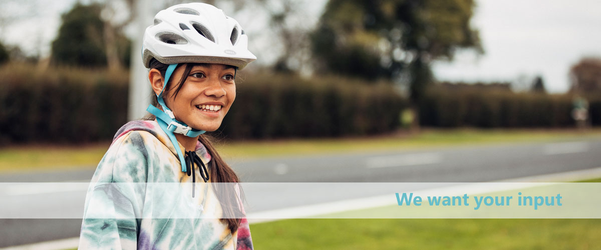 Image of a smiling girl wearing a bike helmet
