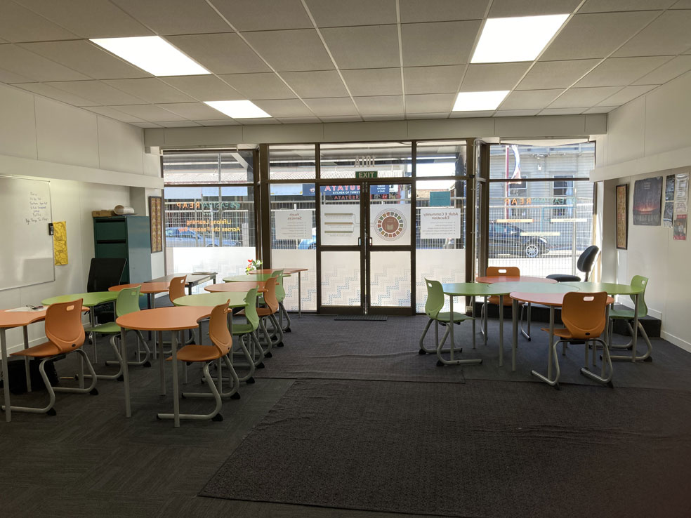 A picture of the inside of Eastbay REAP training facility showing tables and chairs set up