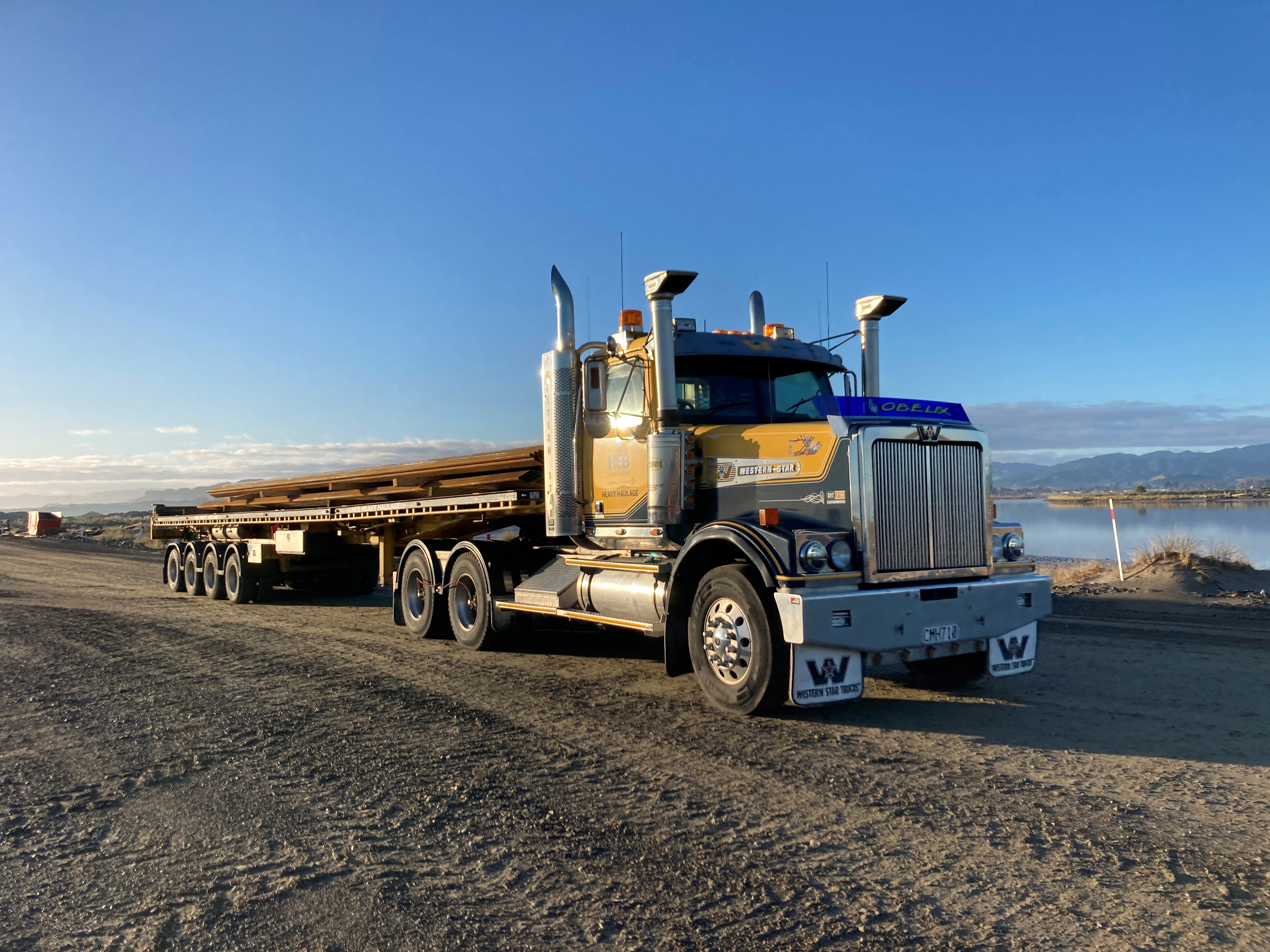 Picture of a large truck with sheet pile on the trailer